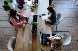 Aerial View of 3 Women Sitting at a Distressed Table